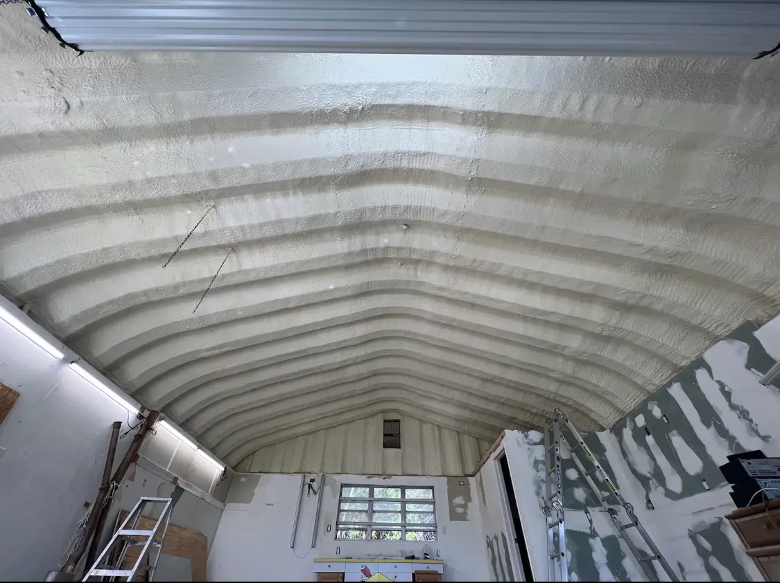 Spray polyurethane foam applied to the underside of a metal roof deck in Palmer